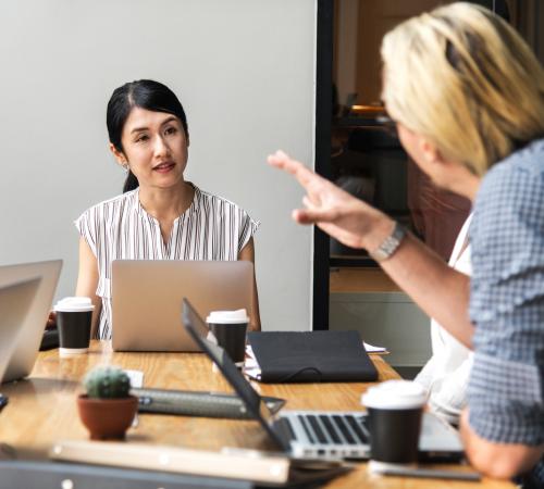 business woman guiding other business woman