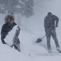 Abby O'Brien, left, and Spencer Couser shovel snow from their sidewalk during a snowstorm Monday, January 28, 2019, in Manitowoc